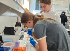 photo of two students working with the lab equipment