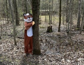 SCHS mascot Stormy the Fox hugs a tree at Macskimming Outdoor Centre